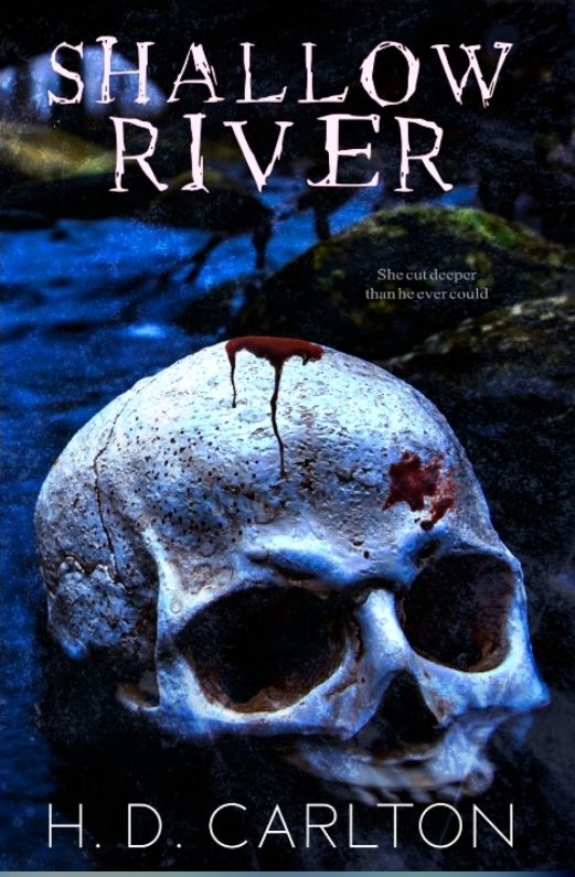 A book titled "Shallow River" by H.D. Carlton. The image depicts a human skull with a bit of blood on it, lying in a very dark area that is illuminated blue by the moon. The text reads, "She cut deeper than he ever could."