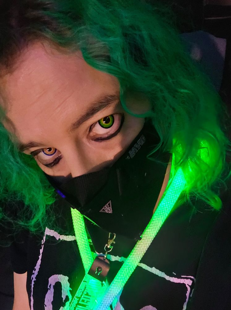 Green haired woman with eyeliner and tech Ninja mask