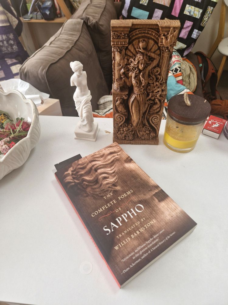 My altar, with two statues of Aphrodite and a book of Sappho's poems on display 