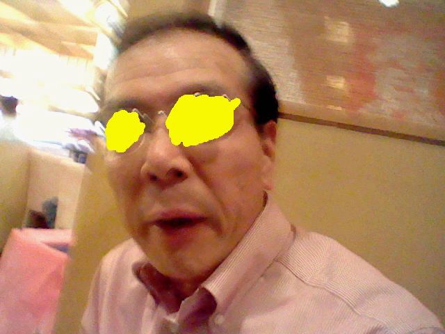 blurry photo (selfie?) of a balding japanese man with yellow scribbled over his eyes