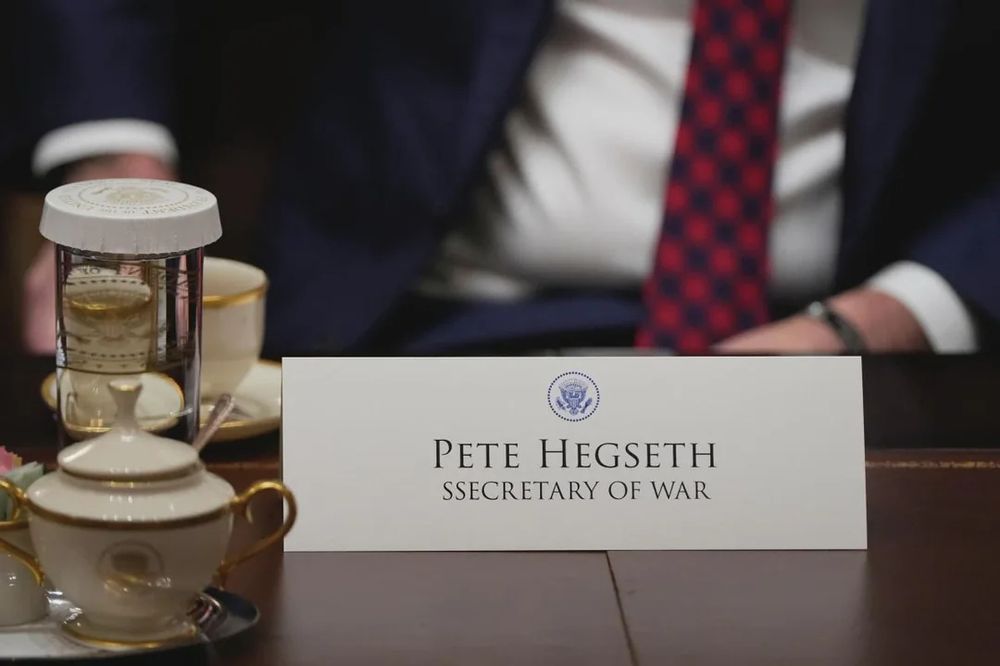 Pete Hegseth with a misspelled nametag reading "SSECRETARY OF WAR"