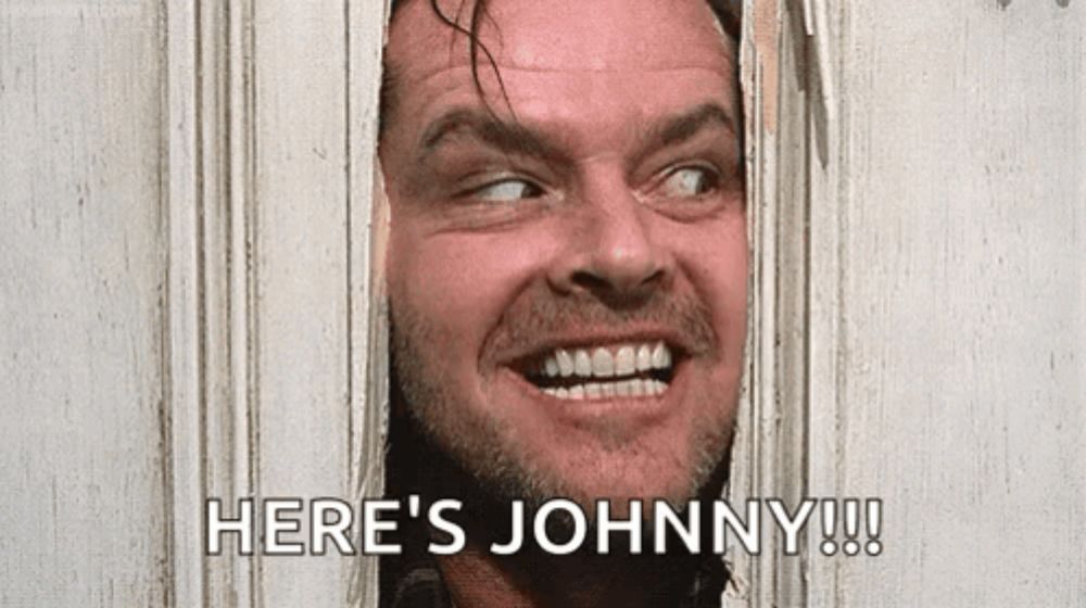 a man is peeking out of a door and smiling with the words `` here 's johnny '' .