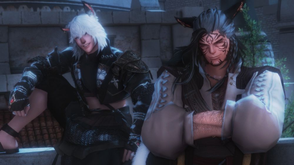 Black Water ( Right ) and Metheos ( Left ) pictured enjoying a breezy night at the Moraby Drydocks. Metheos is sat on a stone guard rail, putting them at eye level with Black Water who is leaning back with their arms folded across their chest. The two seem perfectly at ease with smiles on their faces and the moon's light at their back.