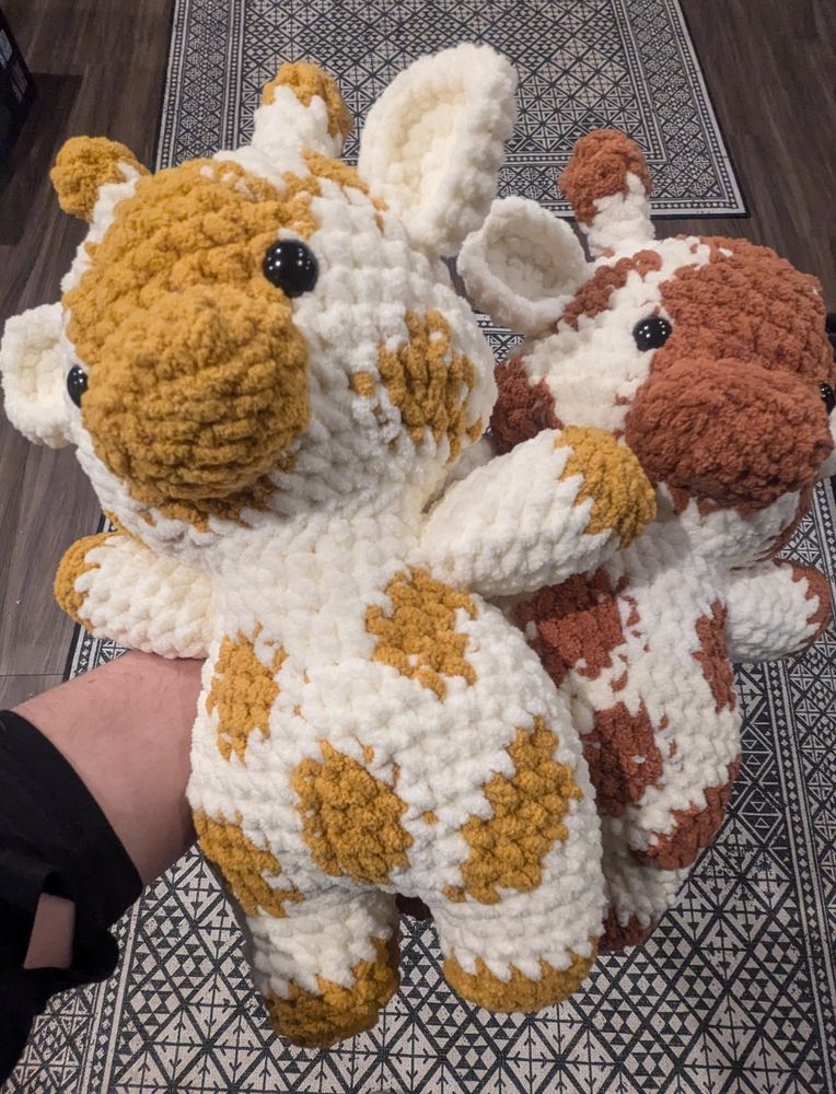 Two crocheted giraffes or cows