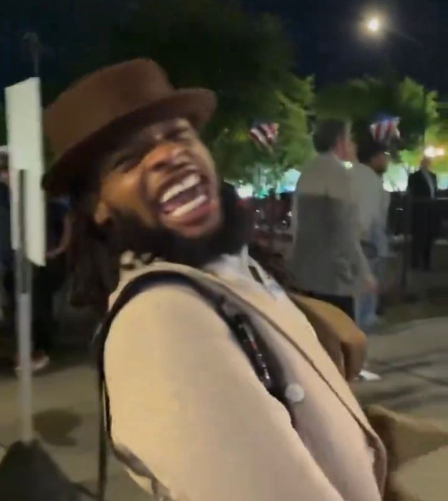 A democrat laughing at the pro-palestine protesters jeering at him