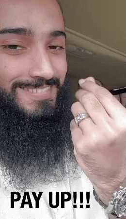 a man with a beard is wearing a ring on his finger and the words pay up !!! are below him