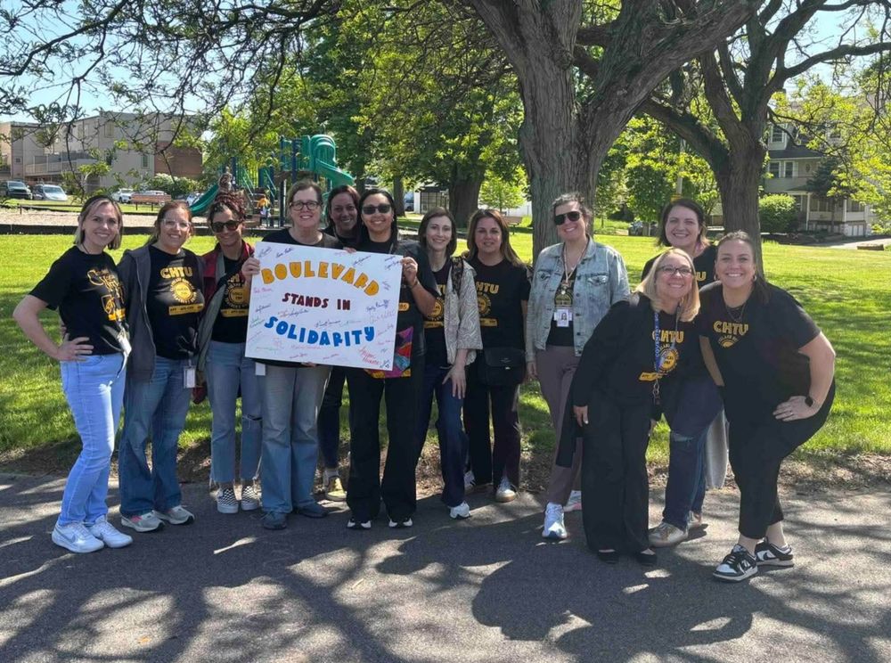CHTU members wearing union shirts and holding signs in support of a fair contract. 