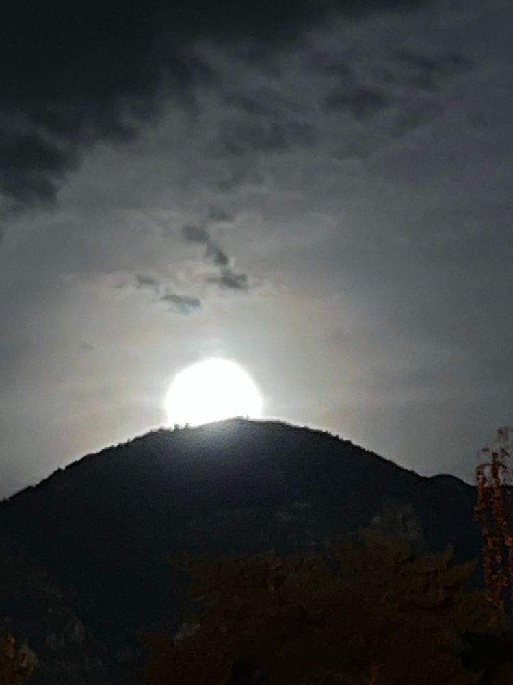 The moon has risen over the mountain more