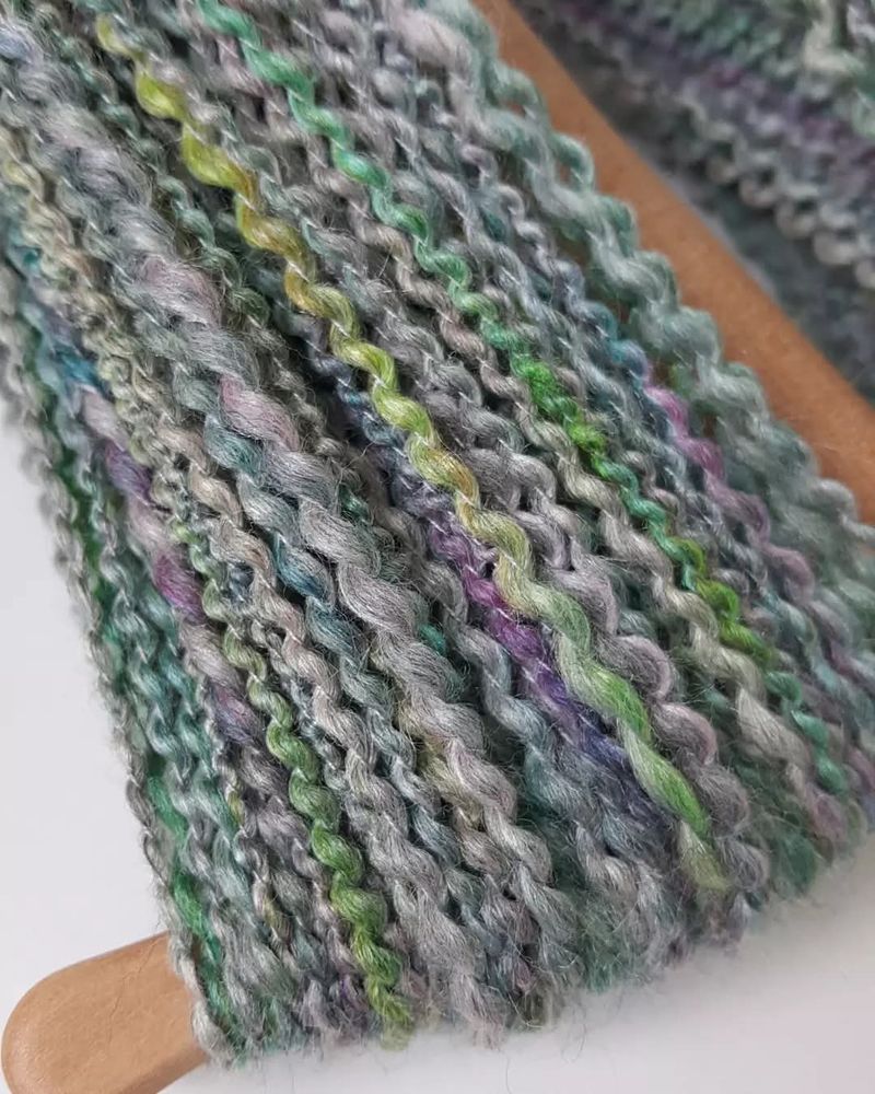 Hand spun merino silk fibre wound on to a niddy noddy. 