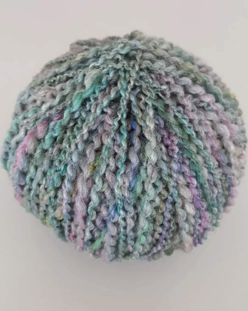 Handspun merino silk fibre wound in to a ball.