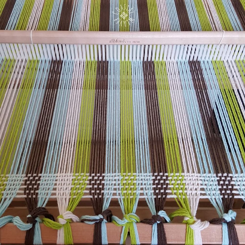 Rigid heddle loom warped with Lilys Sugar N Cream cotton yarn.  