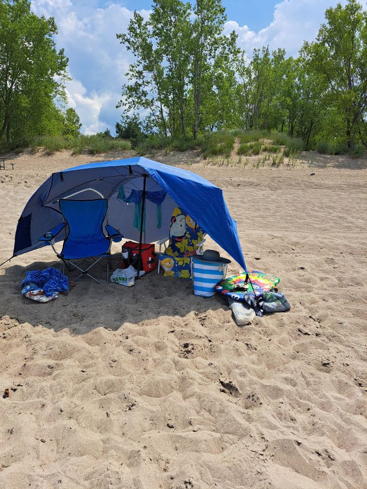 An umbrella cabana on a quiet, sunny beach.