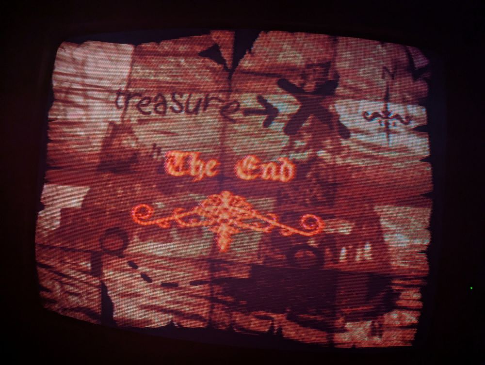 donkey kong country 2 ending screen that shows The End in a very piratey looking font transposed over a piratey treasure map backgroudn