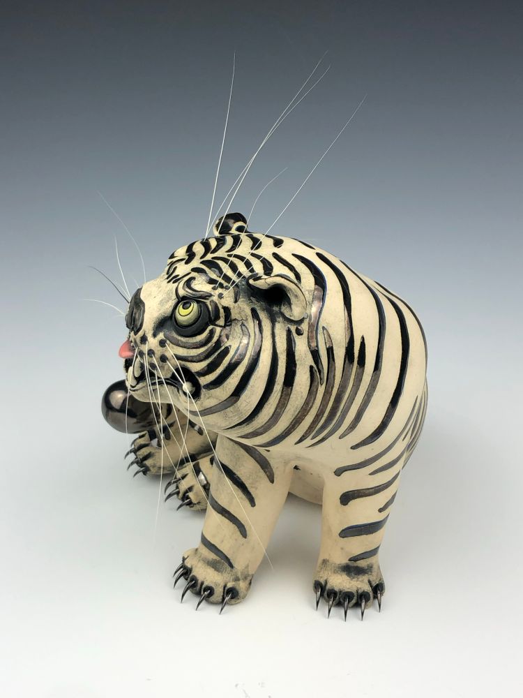 Hand built ceramic tiger sculpture, black metal glazed stripes, steel claws and genuine cat whiskers 
