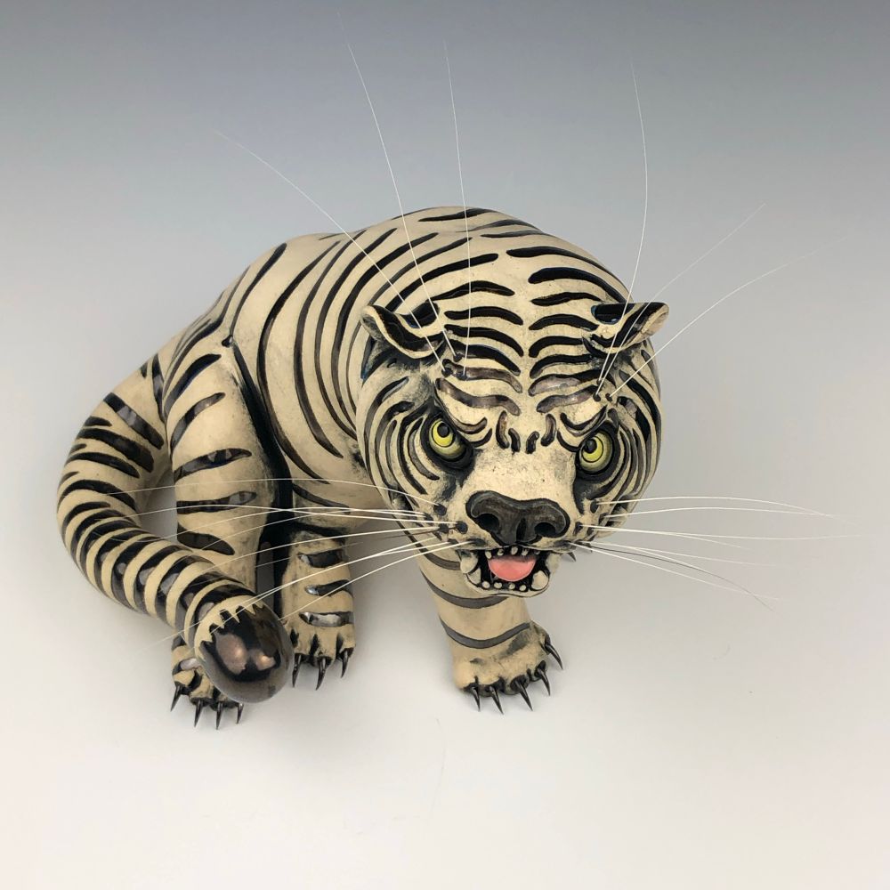 Hand built ceramic tiger sculpture, black metal glazed stripes, steel claws and genuine cat whiskers 
