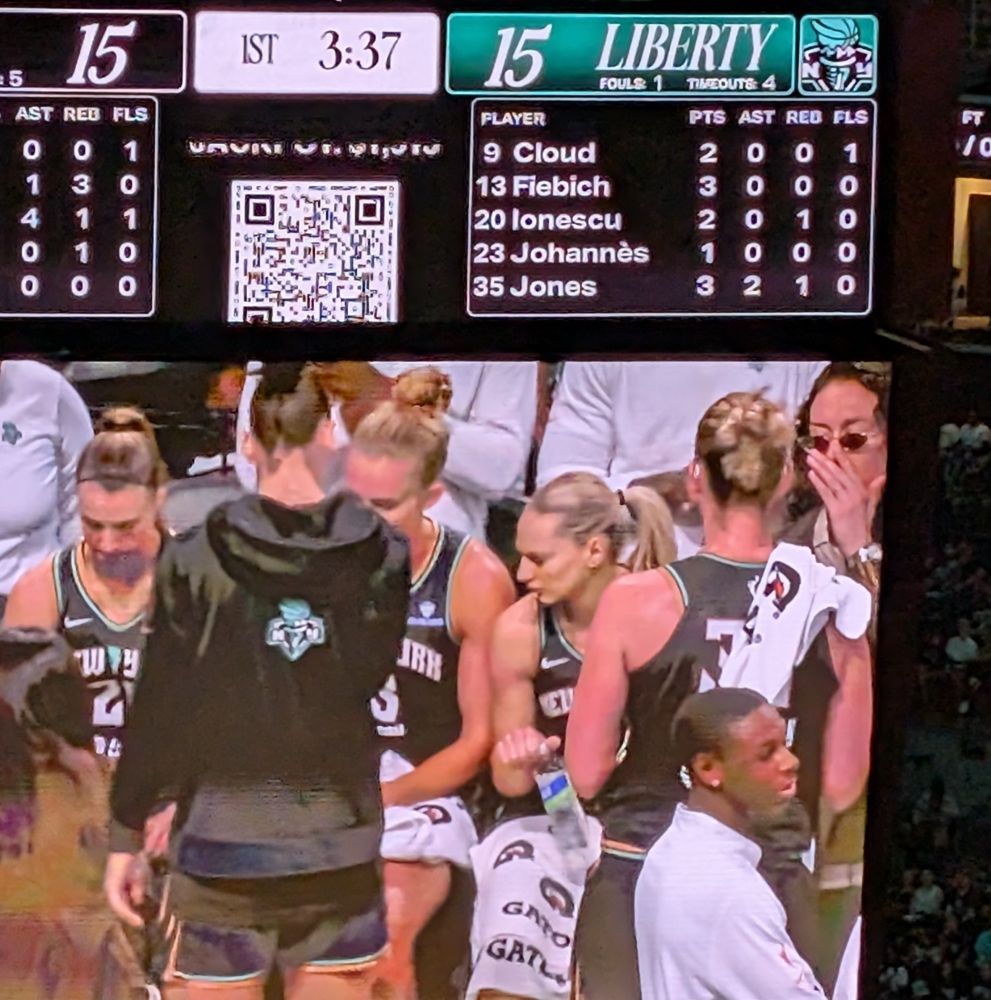 Photo of the jumbotron during a NY Liberty time out with an incognito Breanna Stewart whispering to the uniformed players.