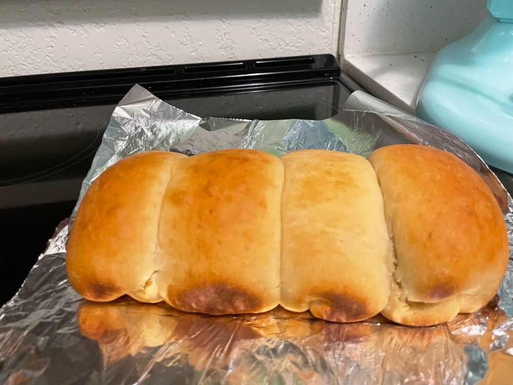 a four part loaf of golden brown under-risen bread