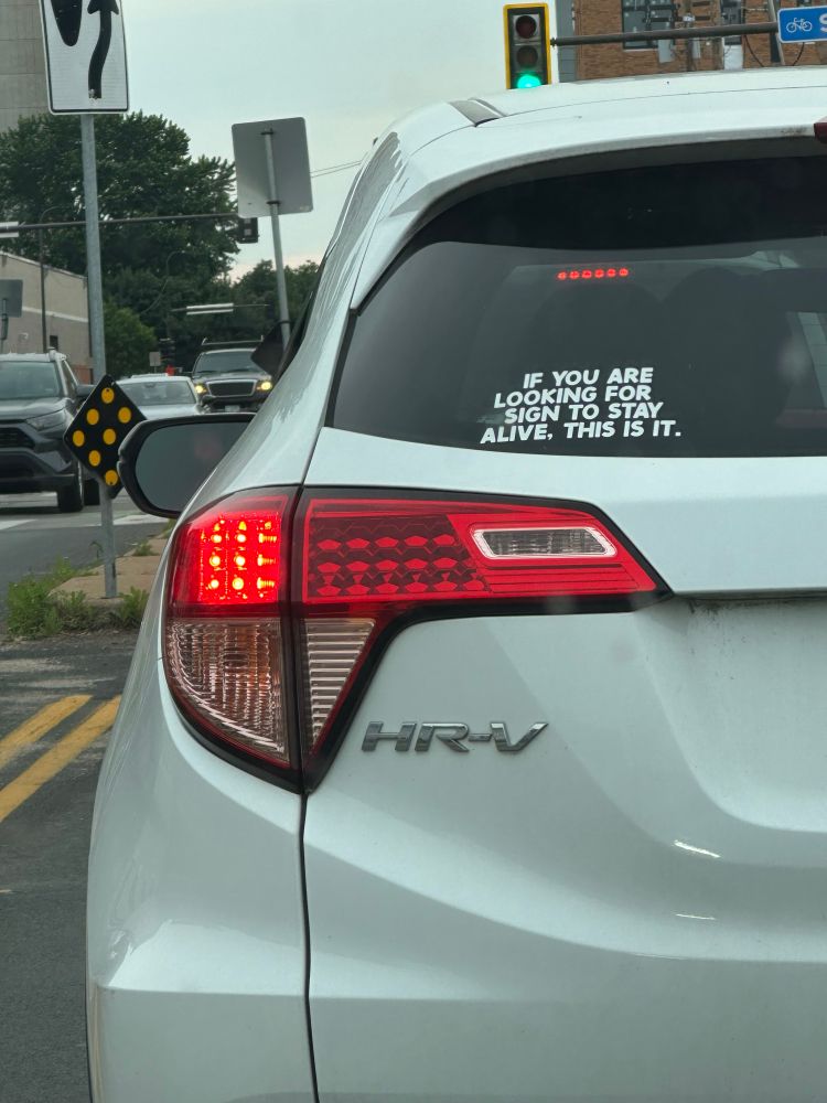 Bumper sticker that says “If you are looking for sign to stay alive. This is it.”