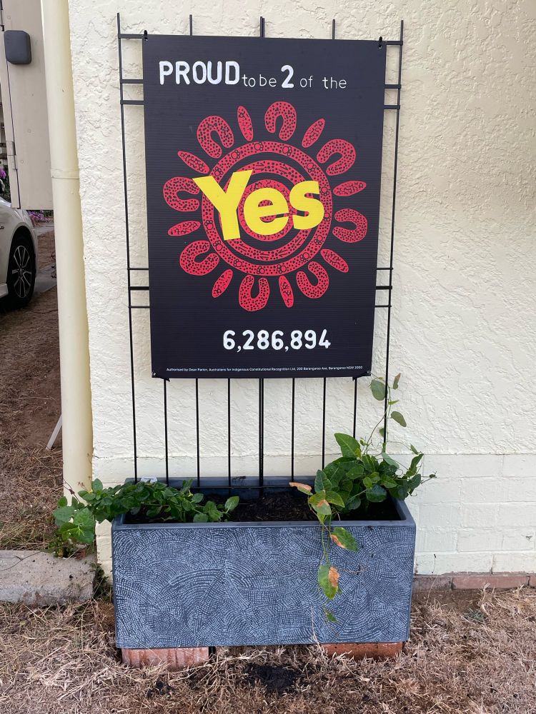 A poster from the Yes campaign with the added words ‘Proud to be 2 of the 6,286,893’. The poster is mounted on garden trellis above a grey planter box