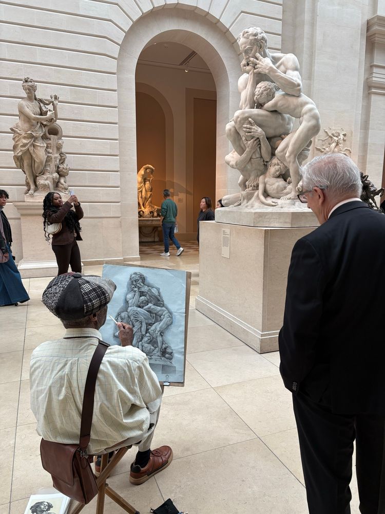 A talented artist drawing a sculpture with onlookers