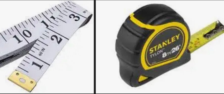Two tape measures: at left, a soft tape measure like you’d see a tailor use, with a golden cap and white tape with black marks and writing. At right, a black and yellow Stanley brand 8 metre tape measure- this is the metal retractable kind with a yellow tape and a silver end that rattles. 