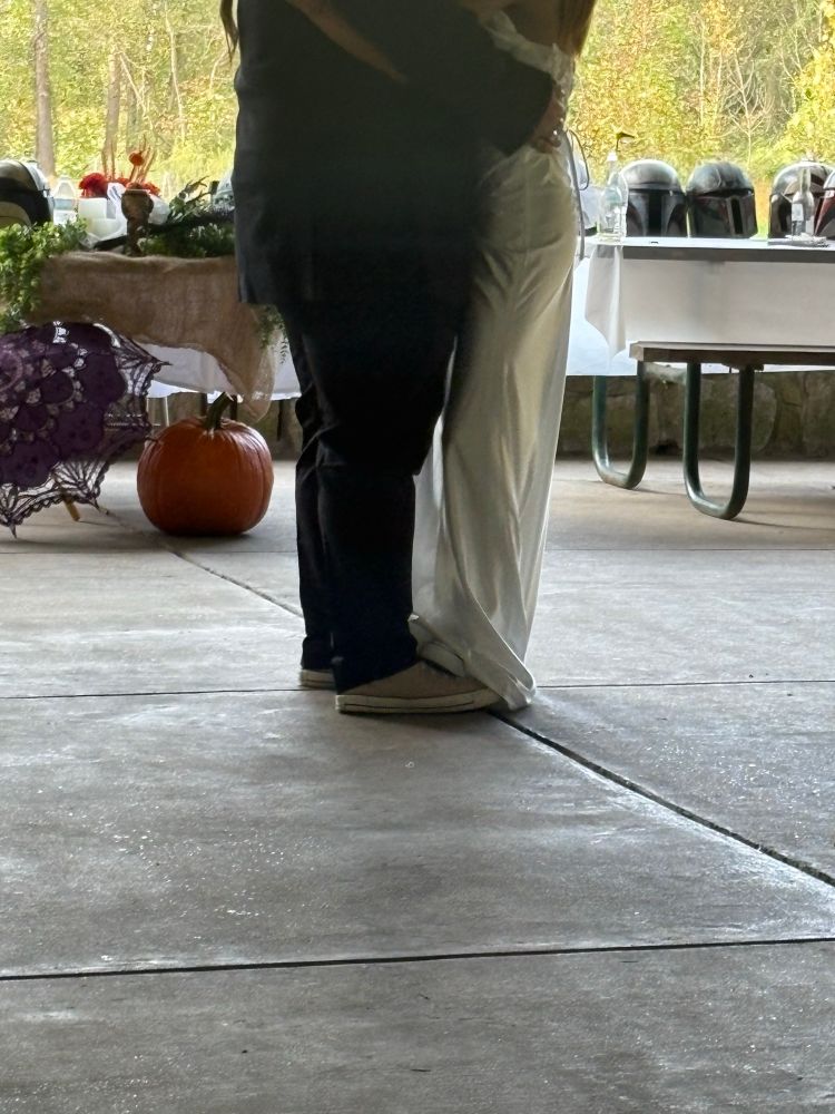 a shot of the bride’s shoes on top of the groom’s shoes during the first dance 