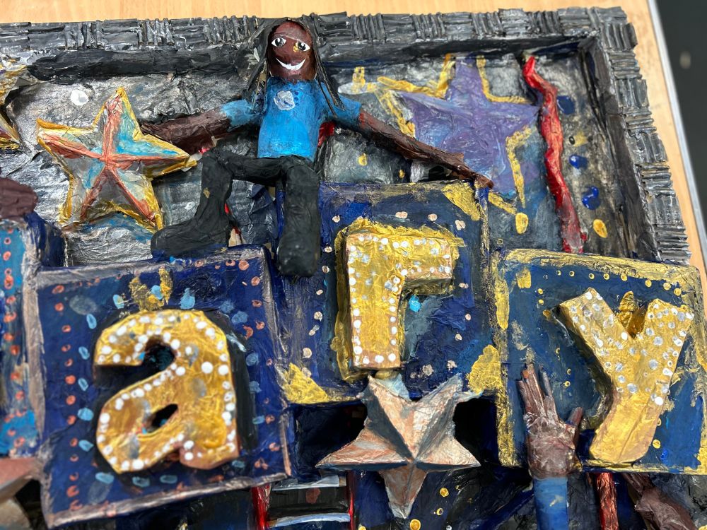 Close up photo of the small models of children created for the display. 