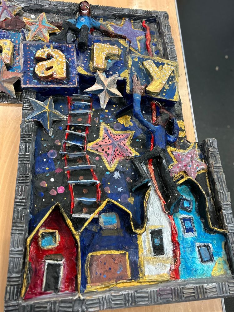 Close up photo of the small models of children created for the display. 