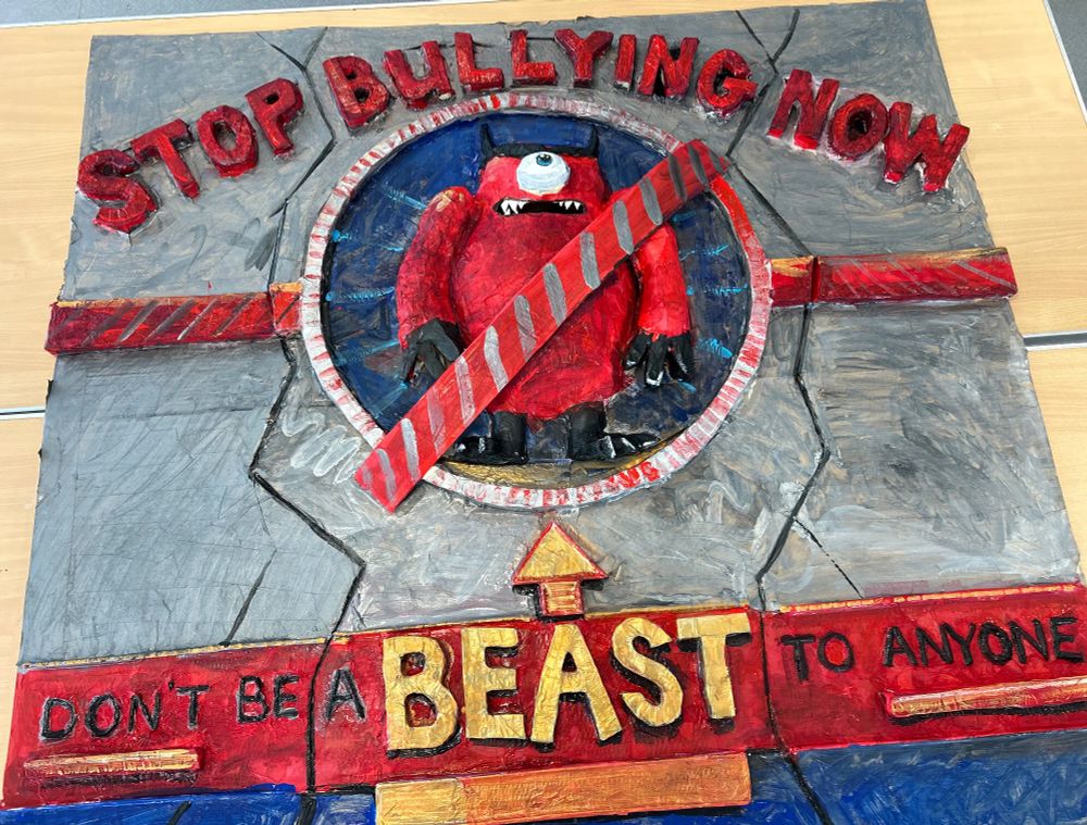 A 3D poster design made in just one day by the students from Avalon special school. The poster is for an anti-bullying campaign, and was designed by Rex, one of the students. The wording says "don't be a BEAST to anyone" and in the centre an angry looking monster is trapped inside a 'no entry' sign. The monster is red, with one large angry eye, and black little horns, it doesn't look too happy that it's been caged. 