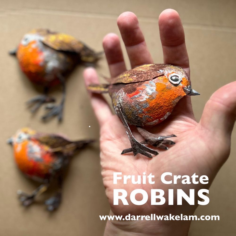 Small birds (robins) made from circles cut from supermarket fruit crates 