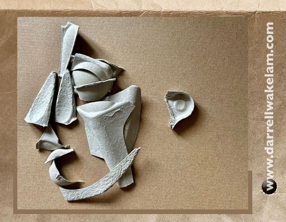 A simple face made by rearranging parts cut from an egg carton. 