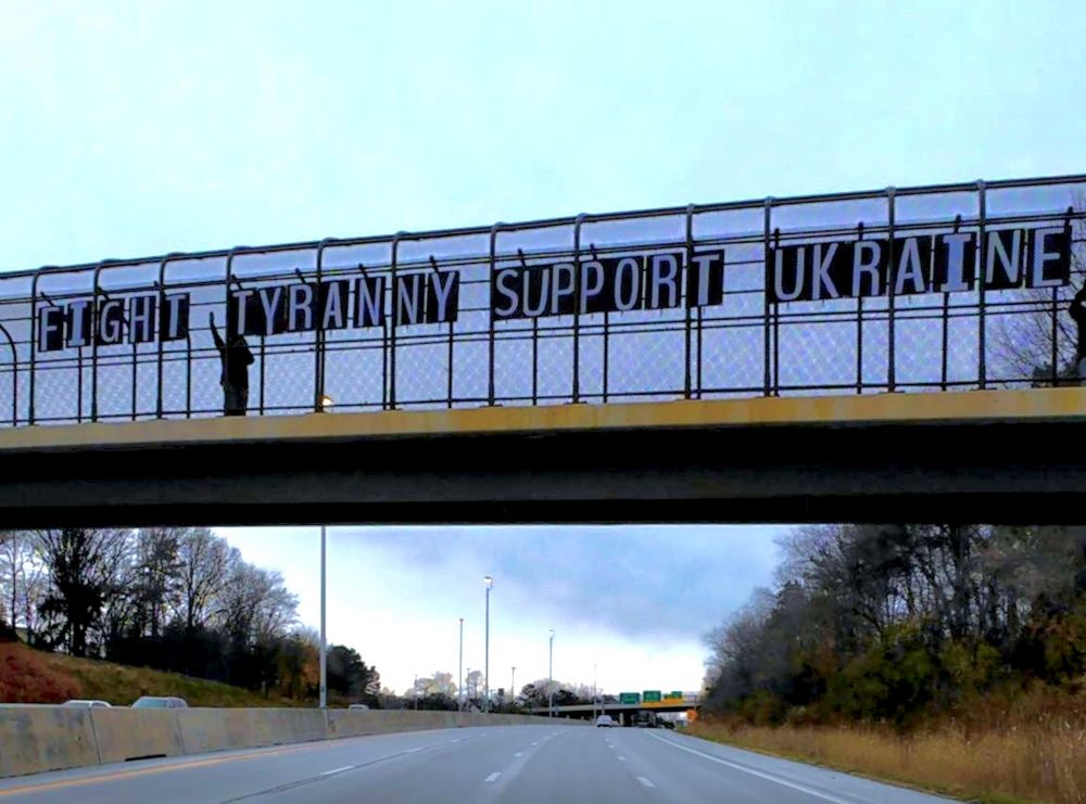 A highway overpass in Akron Ohio showing letters that spell out FIGHT TYRANNY FREE UKRAINE 