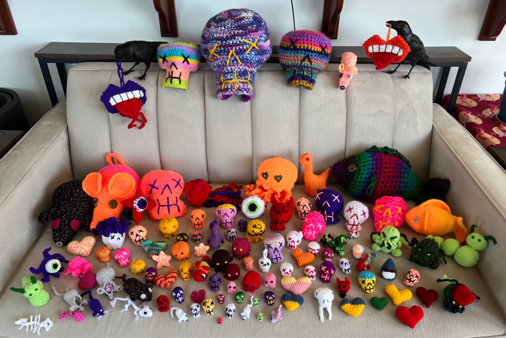 A multicolored menagerie of crocheter skulls, fish, hearts, cthulhus, eyeballs, caterpillars and mice of various sizes