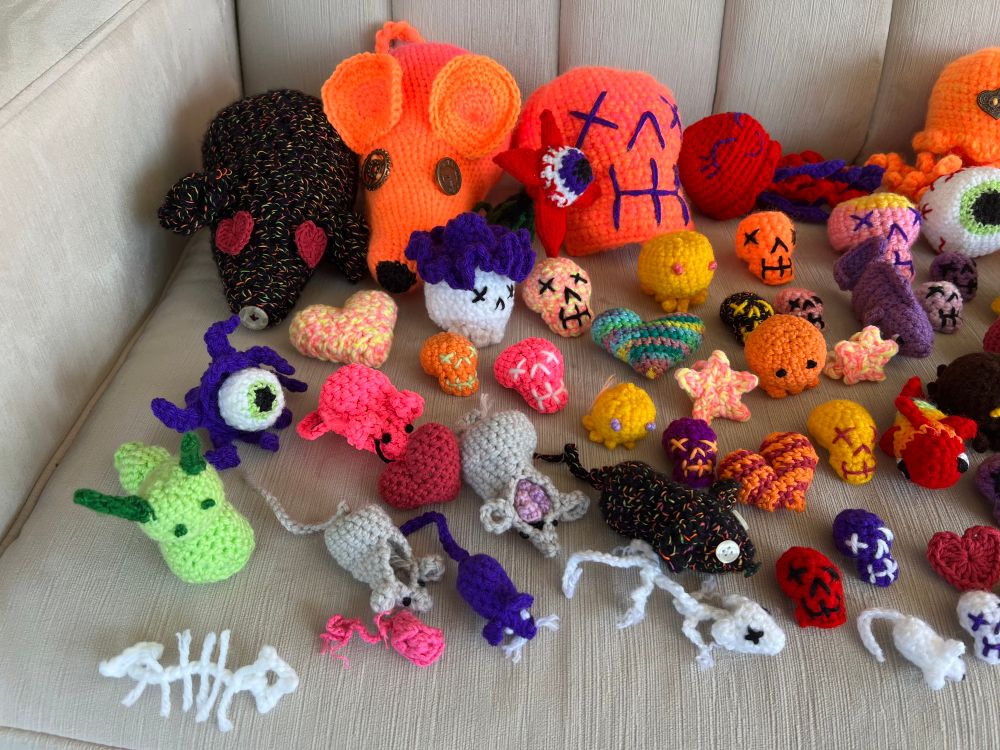 A multicolored menagerie of crocheter skulls, fish, hearts, cthulhus, eyeballs, caterpillars and mice of various sizes