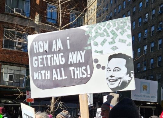 Sign says: How Am I Getting Away With All This?