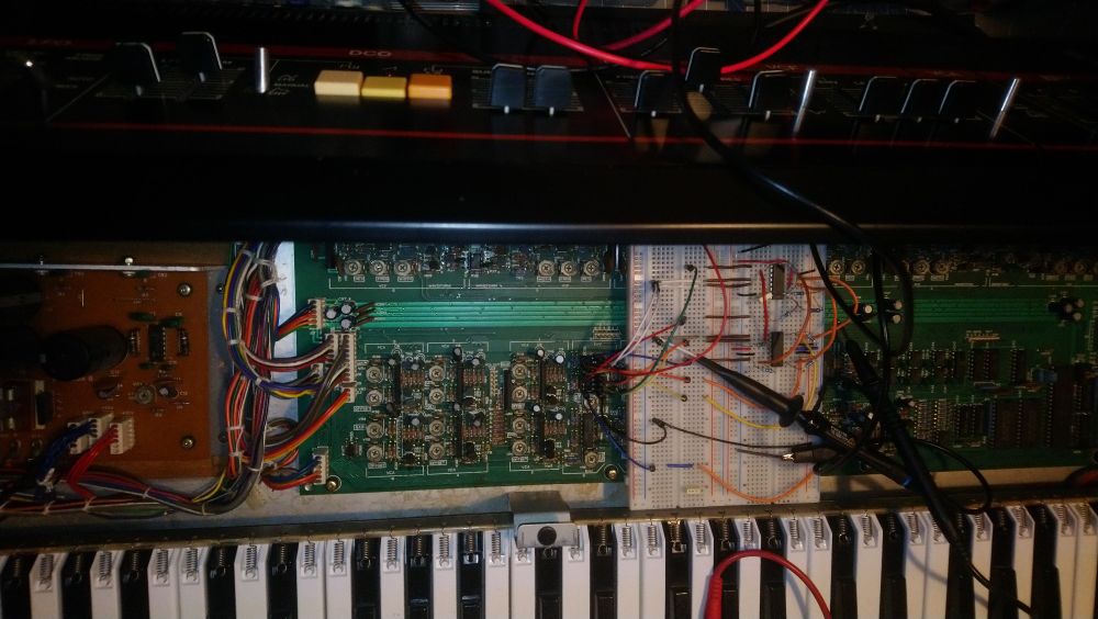 A rat's nest of wires in a Roland Juno 6, unabashedly open to the elements as I work on a replacement circuit for a broken and rare as hen's teeth IR3R01 envelope generator. Fun times. 
