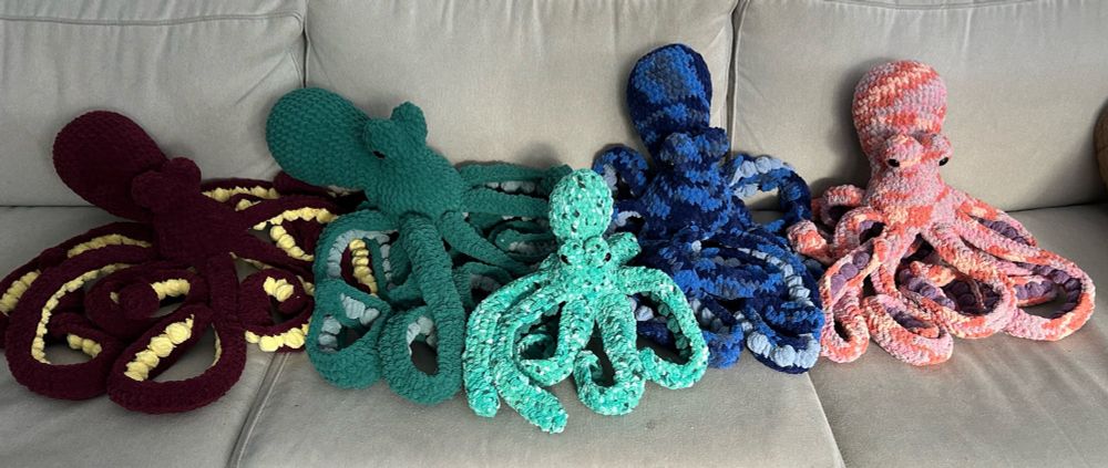 5 crocheted octopuses, each a different set of colors