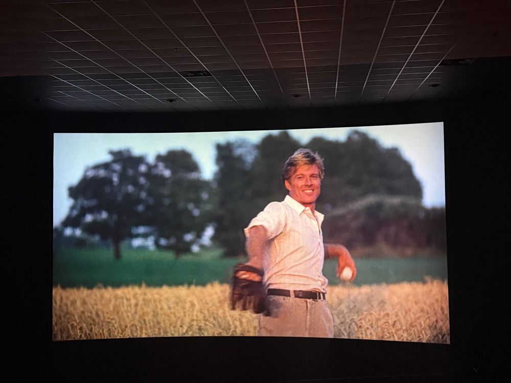 Photo taken in a movie theater of the last shot of the movie, The Natural, wherein Robert Redford’s character is throwing a baseball.