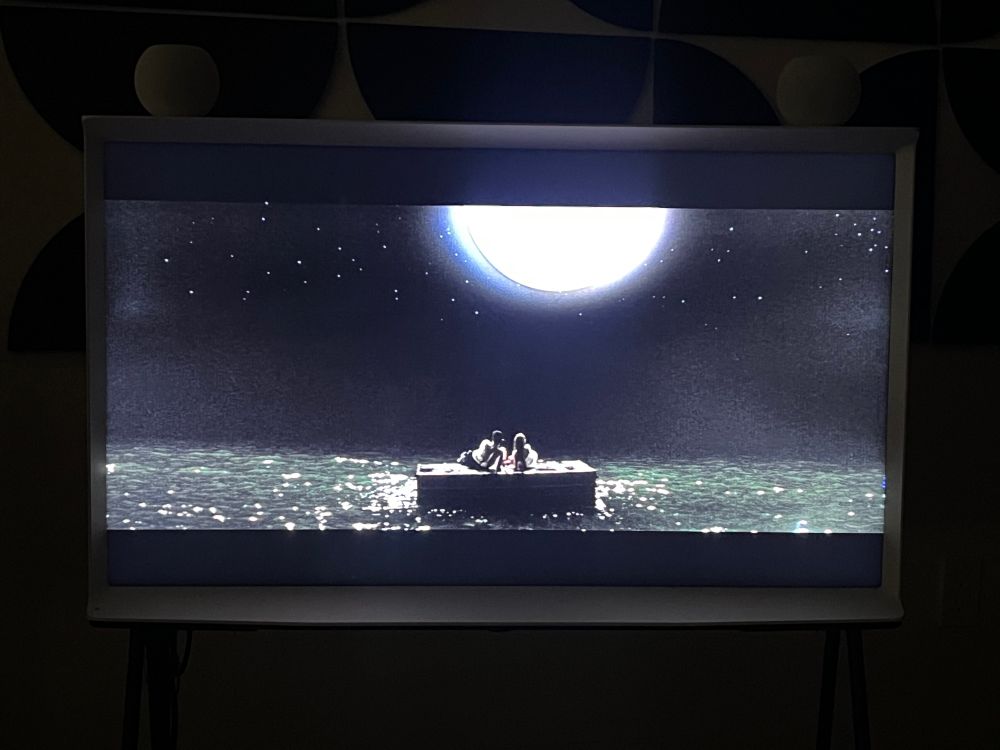 Joe and Patricia floating at sea on their luggage raft.