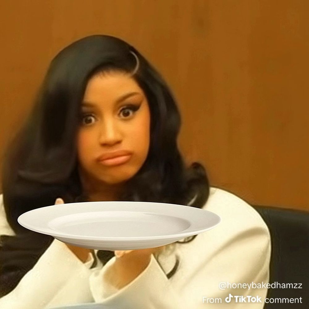 Cardi B holding a plate. 