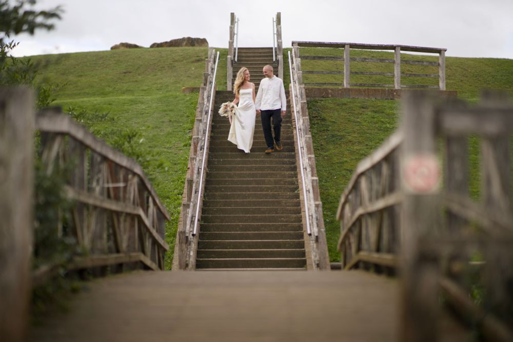 Me and my wife walking down the stairs. We wear formal wedding clothes. I look ok, my wife looks stunning. 