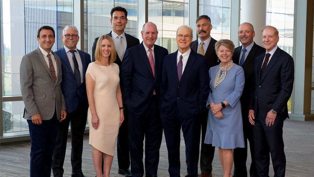 The nine faculty members honored and invested as endowed professors stand with Chancellor Michael F. Collins (center). From left to right: Christopher M. Sassetti, PhD; Craig L. Peterson, PhD; Stephenie C. Lemon, PhD; Richard I. Gregory, PhD; Terence R. Flotte, MD; Oliver Rando, MD, PhD; Anne C. Larkin, MD; Paul Thompson, PhD; and Kenneth L. Rock, MD 