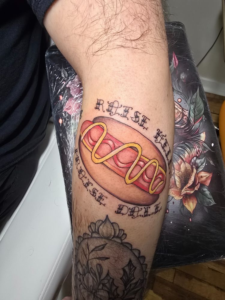 Hot dog tattoo with the text Raise Hell, Praise Dale around it