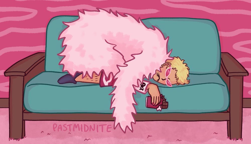 doffy curled up on a couch frowning and clutching a bar of half eaten chocolate with chocolate smeared around his mouth
