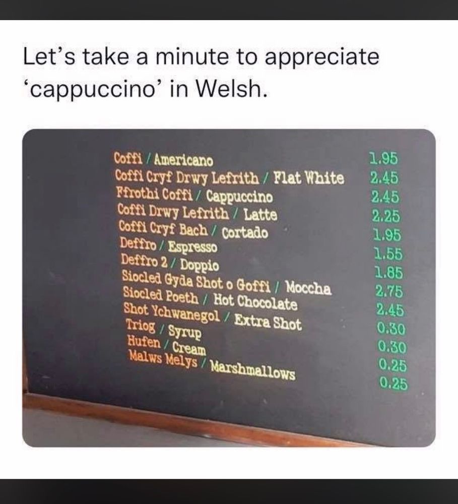 Photograph of a coffee shop menu with drinks’ names translated into Welsh. The third item on the list is Cappuccino which in Welsh is Ffrothi Coffi 