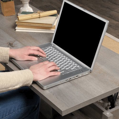 Animated gif of laptop on a coffee table. Picture zooms in to reveal it is a PowerBook G4.