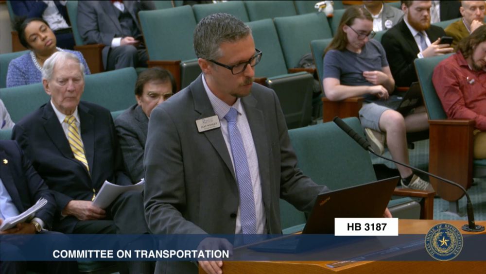 Another screenshot of the hearing, but its a little more zoomed in, so the top of the goose's head is cut off, but the toy train is now resting on top of the goose.