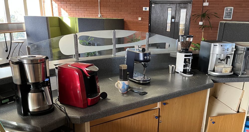 photo of the worktop where I make coffee in the office - with my aeropress surrounded by a growing selection of fancy coffee machines!