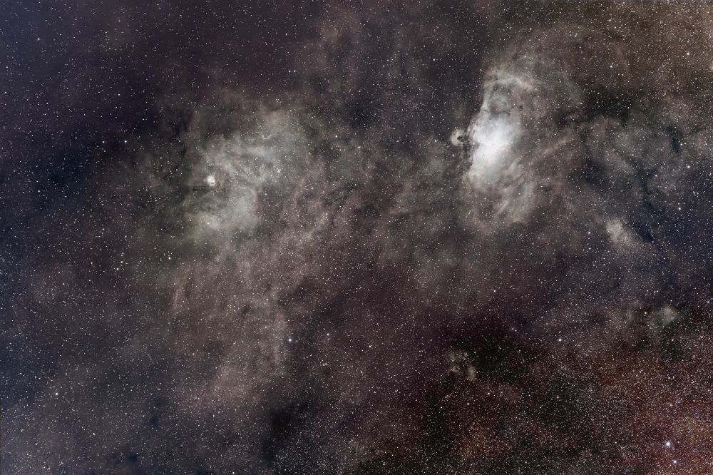 Two celestial heads shine as portraits from a nebulous background.