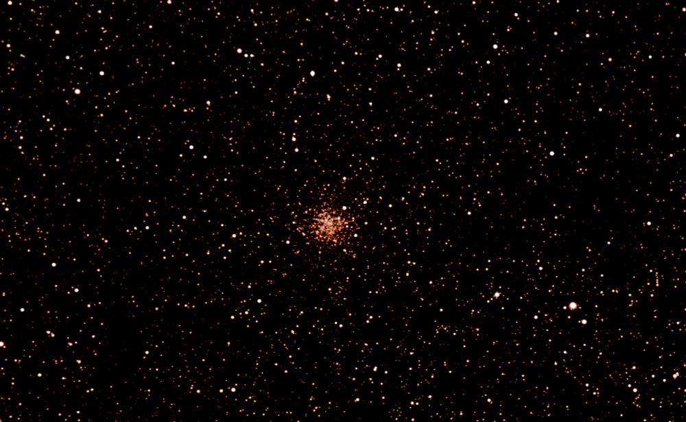 An unusual globular cluster with a concentration of stars with a red cast in the middle of the image. More details in my gallery: https://app.astrobin.com/i/due5g2